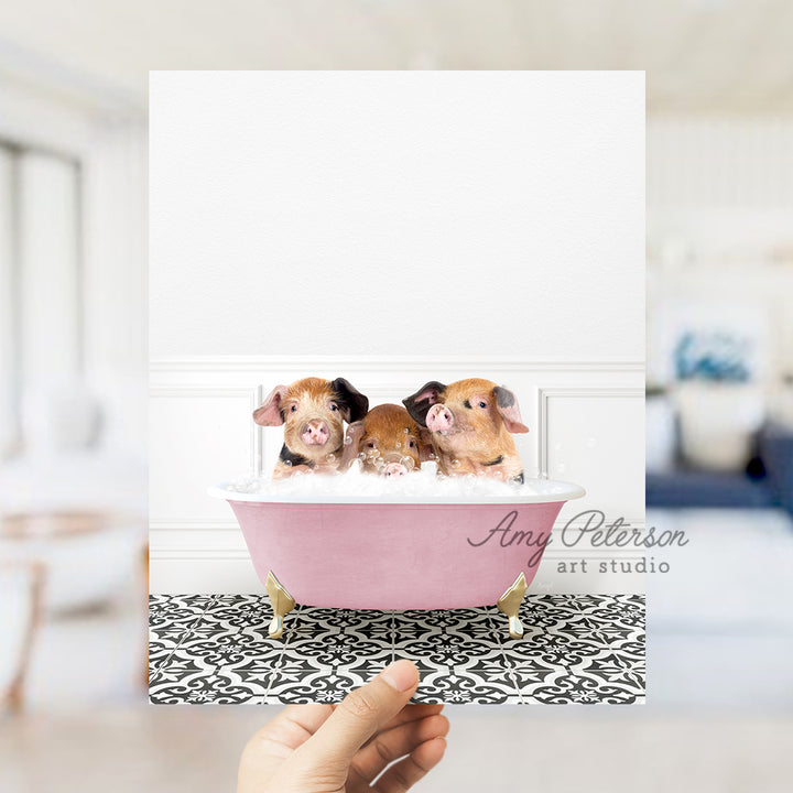 a person holding a card with three little dogs in a bathtub