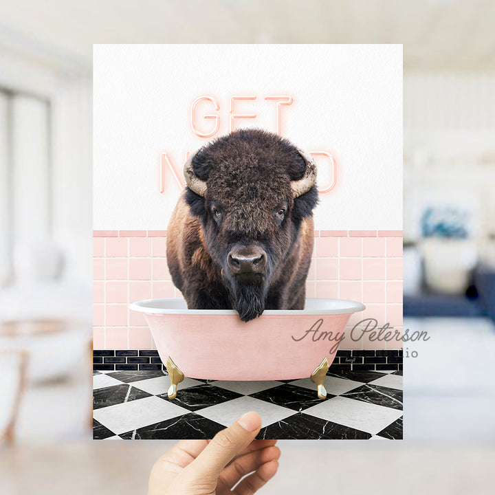 a person holding up a card with a picture of a bison in a bathtub