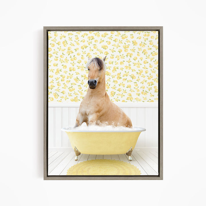 A light brown horse is sitting in a yellow bathtub filled with water, surrounded by a yellow floral wallpaper.