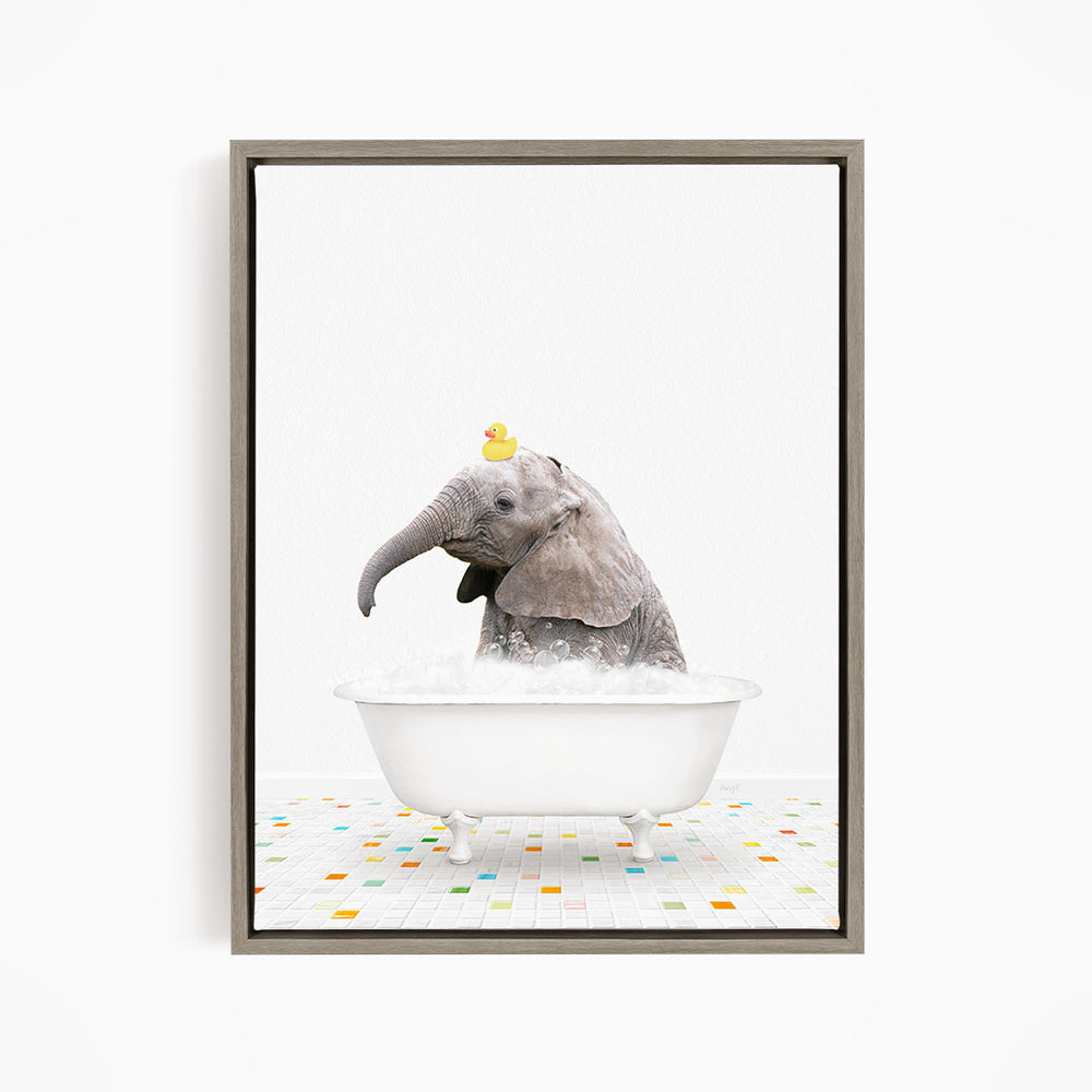 A baby elephant sitting in a white bathtub, with a yellow rubber duck perched on its head.