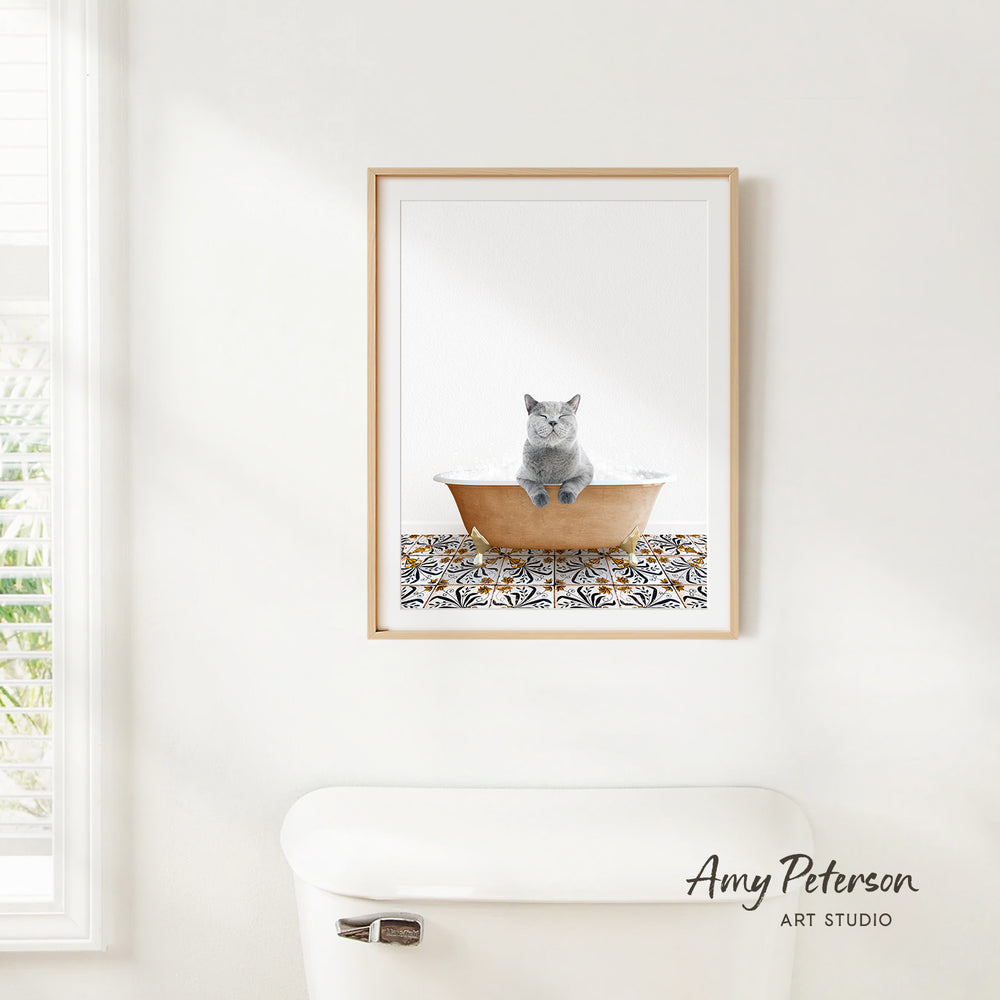 A framed image of a gray cat sitting in a bathtub, with a patterned tile floor below.