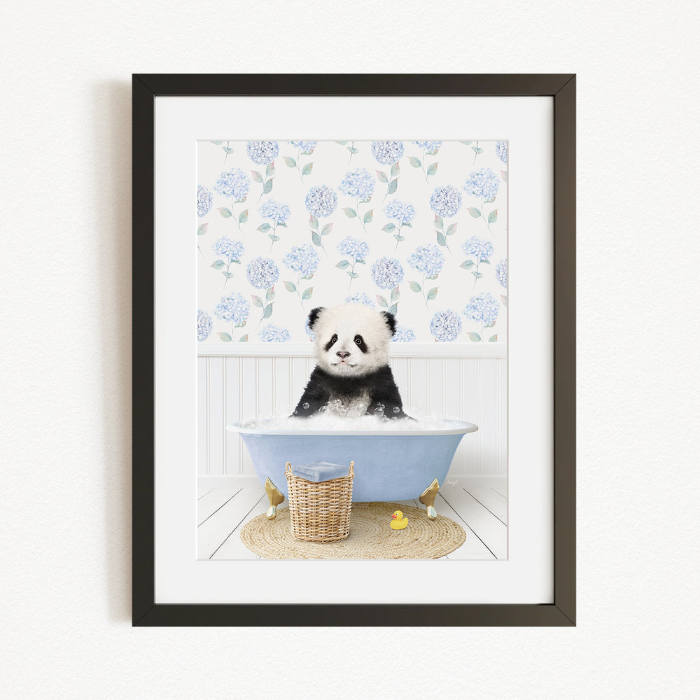 A panda bear sitting in a blue bathtub filled with bubbles, surrounded by a floral patterned wall and a basket of rubber ducks.