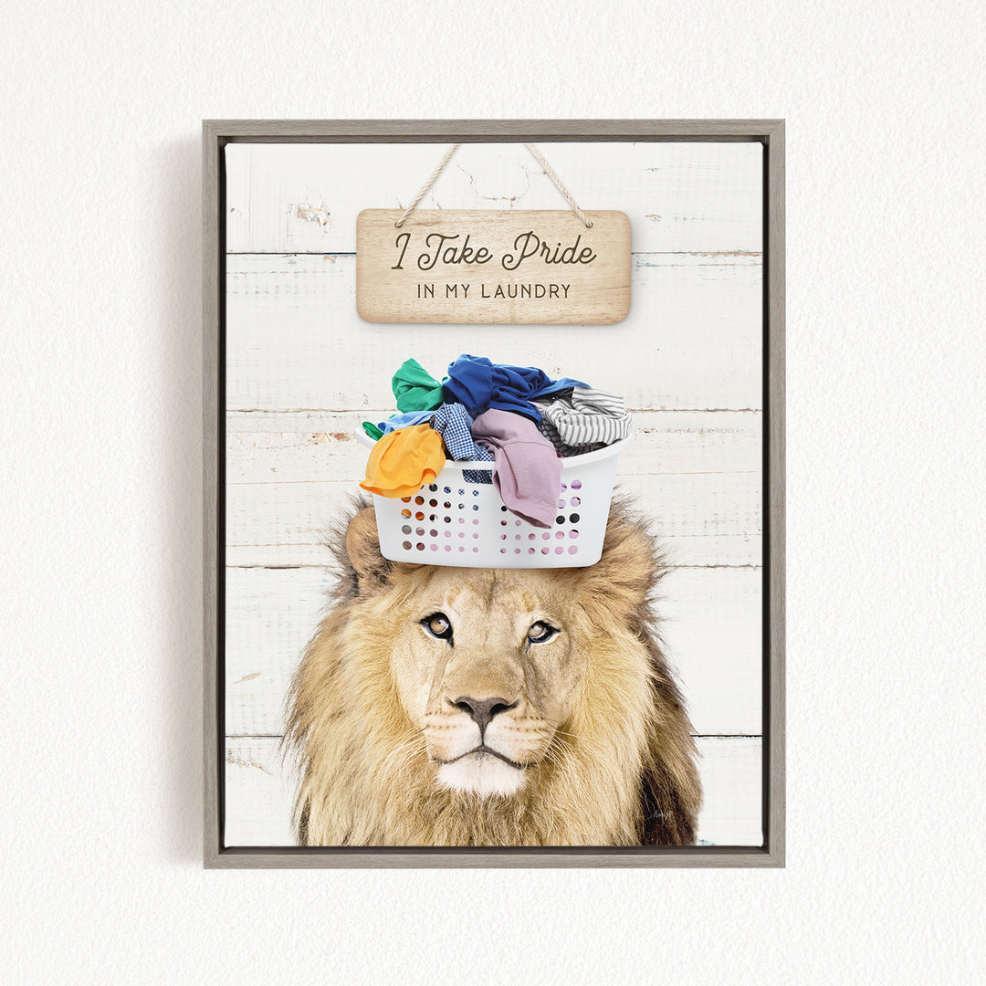A framed image of a lion with a basket of laundry on its head, accompanied by a wooden sign that reads "I Take Pride in my laundry".