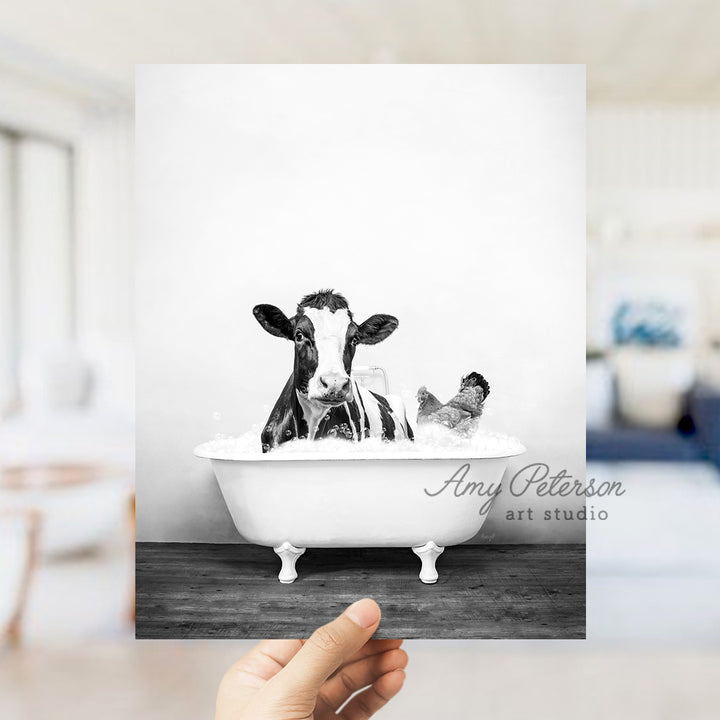 a black and white photo of a cow in a bathtub