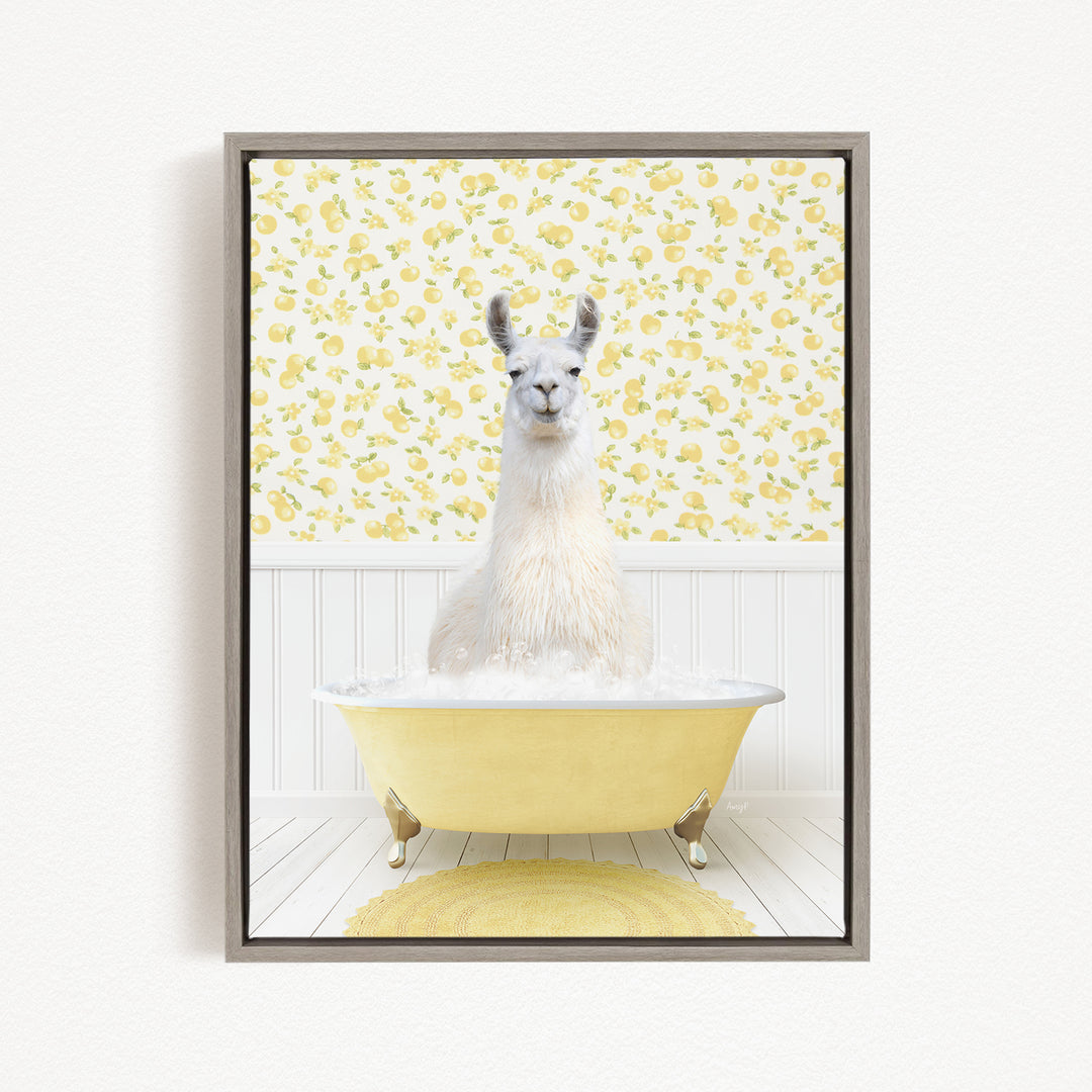 A white llama sitting in a yellow bathtub filled with bubbles, surrounded by a yellow and white floral patterned wall.