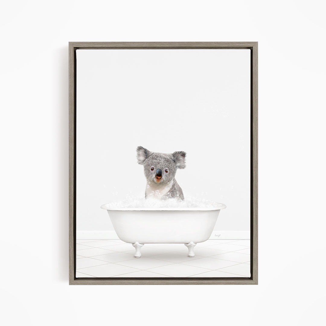 A koala sitting in a white bathtub filled with water.