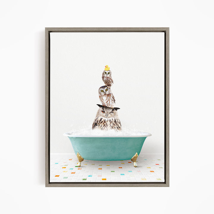 A framed image depicting three owls sitting in a green bathtub filled with bubbles, with one of the owls wearing a yellow hat.