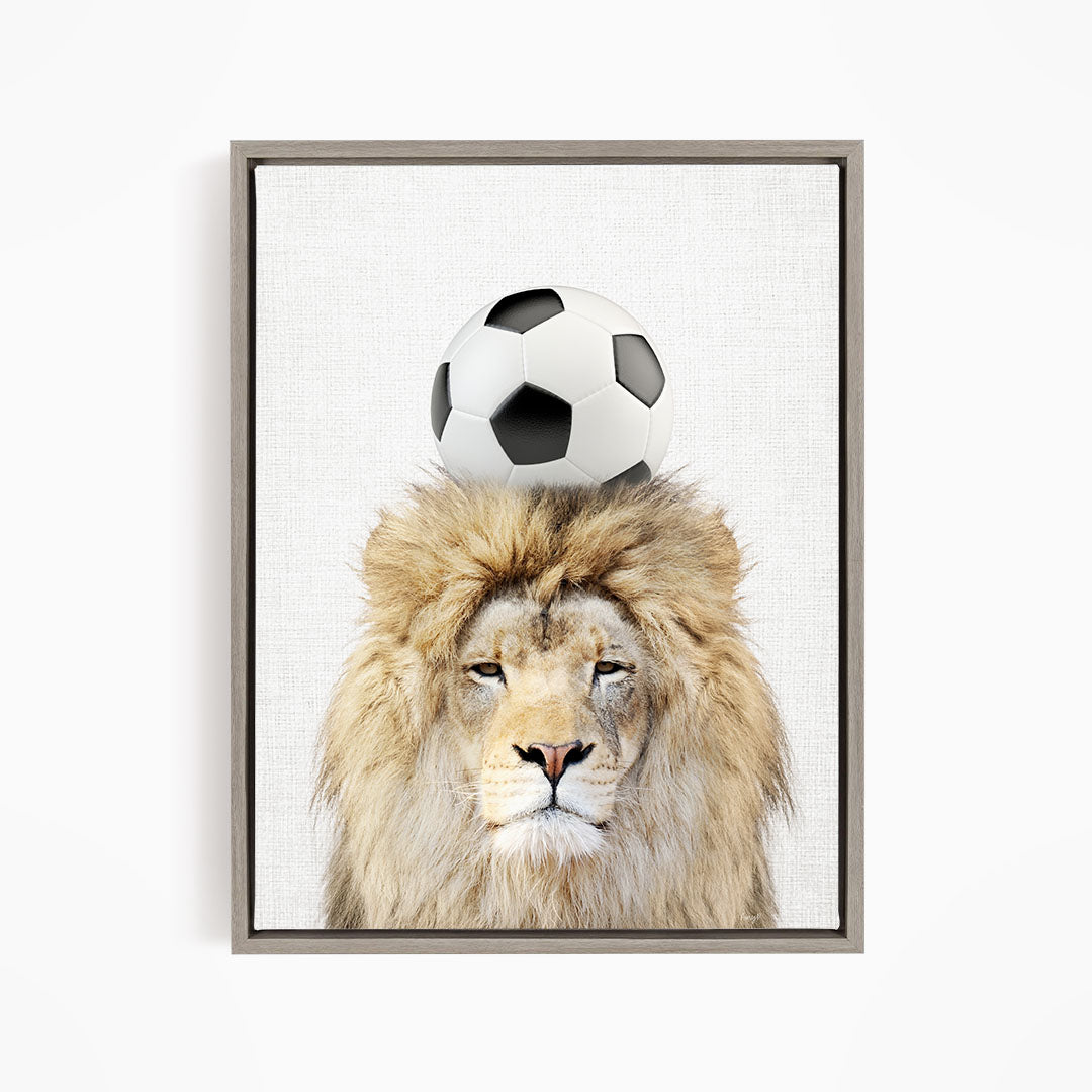 A lion with a soccer ball on its head, creating a playful and whimsical scene.