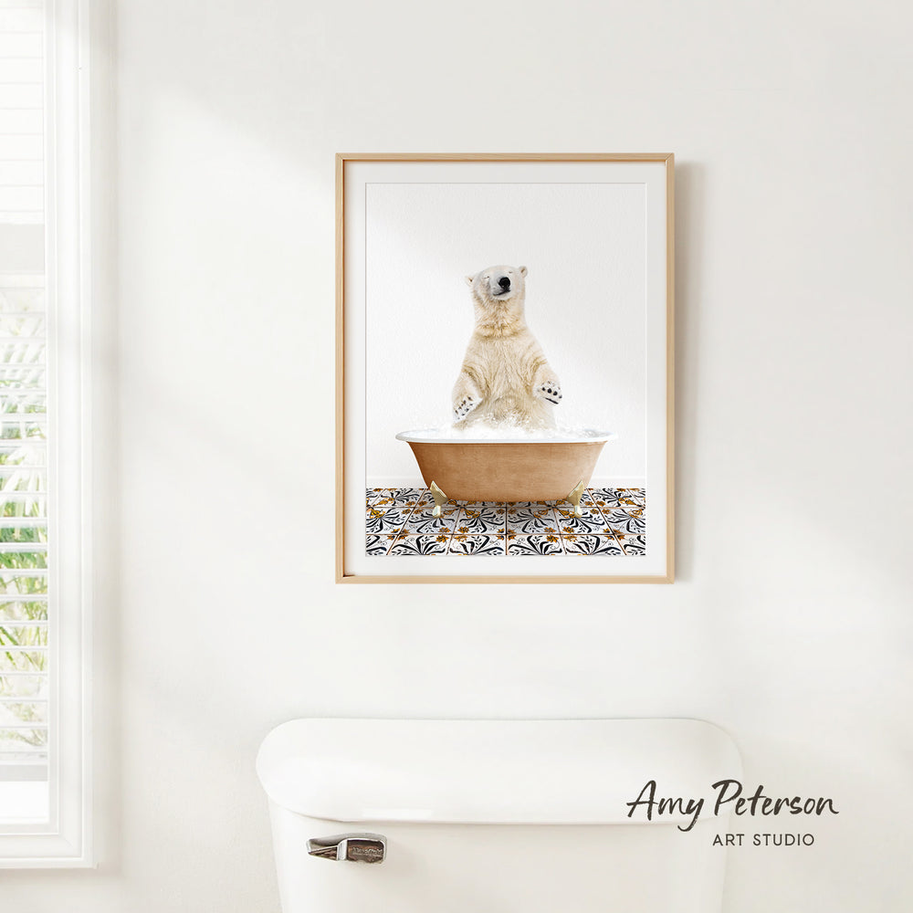 A framed image of a polar bear sitting in a bathtub, with a patterned mat on the floor.