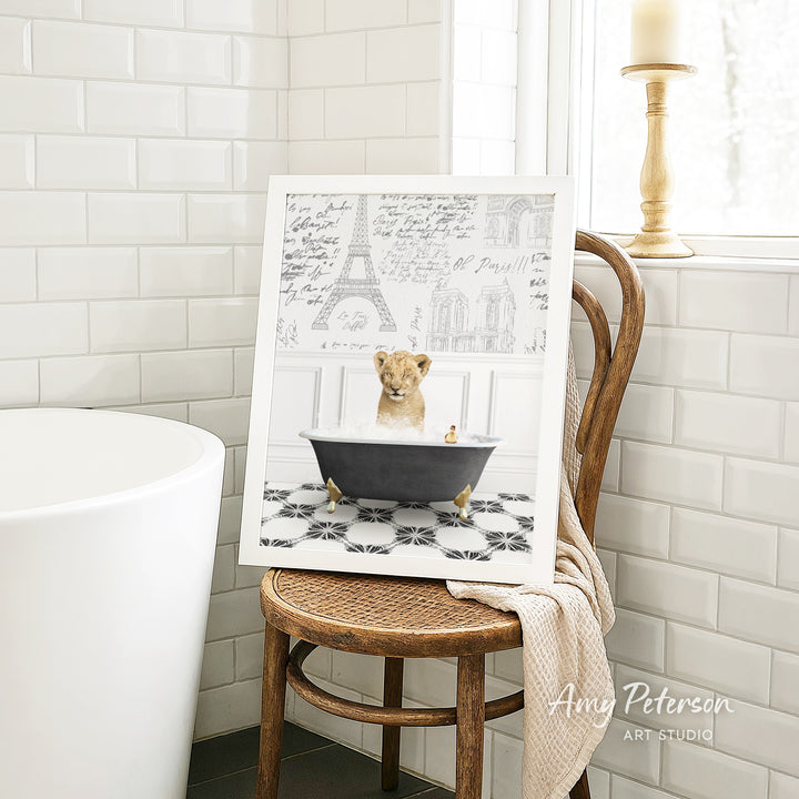 A framed image of a lion sitting in a bathtub, surrounded by a tiled bathroom setting.