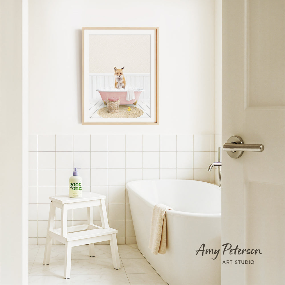 A bathroom with a white bathtub, a stool, and a framed image of a cat sitting in a pink bathtub.