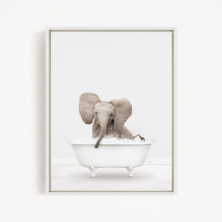 A baby elephant sitting in a white bathtub filled with water, appearing to enjoy the bath.