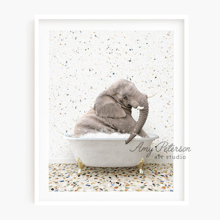 a baby elephant sitting in a bath tub