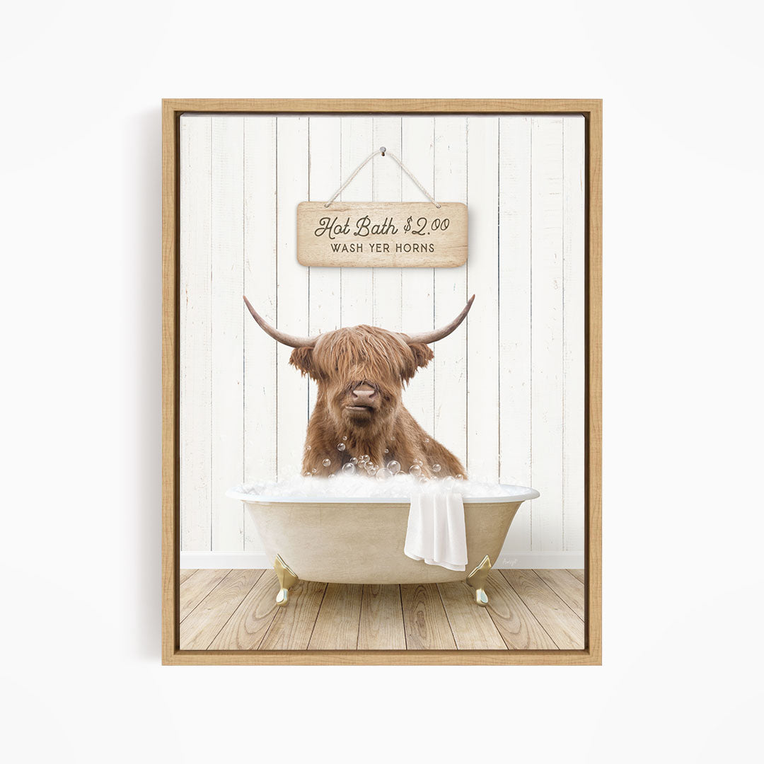 A brown cow with long horns is sitting in a bathtub filled with water, with a sign above it that reads "Hot Bath $2.00 WASH YOUR HORSES".