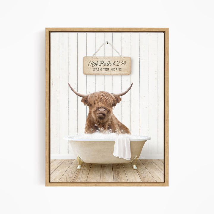 A brown cow with long horns is sitting in a bathtub filled with water, with a sign above it that reads "Hot Bath $2.00 WASH YOUR HORSES".