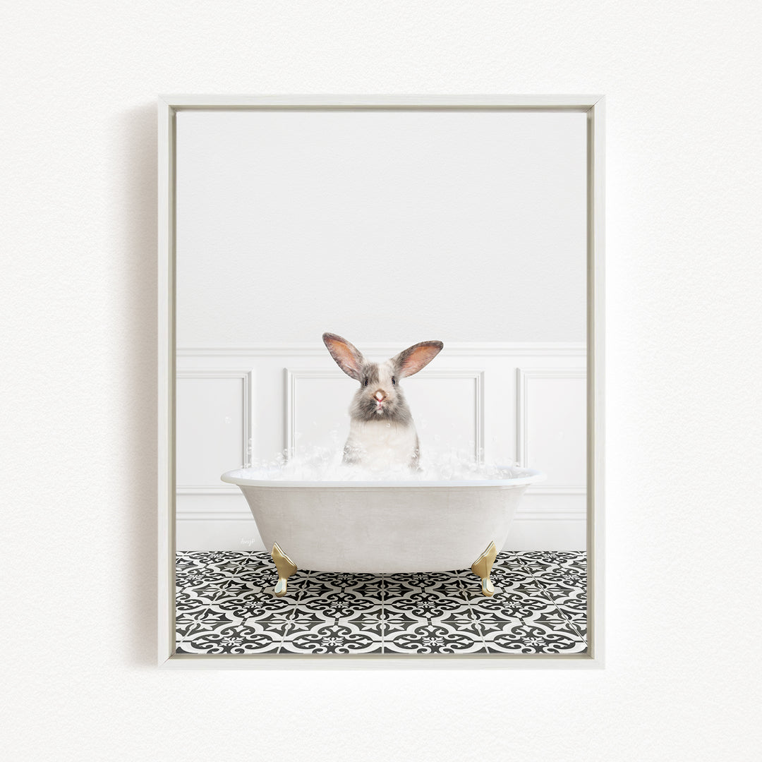 A white rabbit sitting in a white bathtub filled with water, surrounded by a black and white patterned floor.