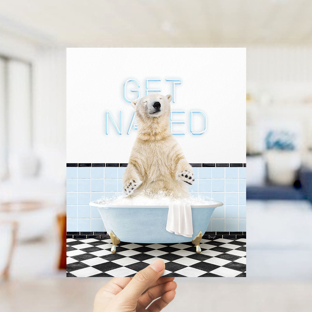 A polar bear sitting in a bathtub with the words "GET NAKED" written on the wall behind it.