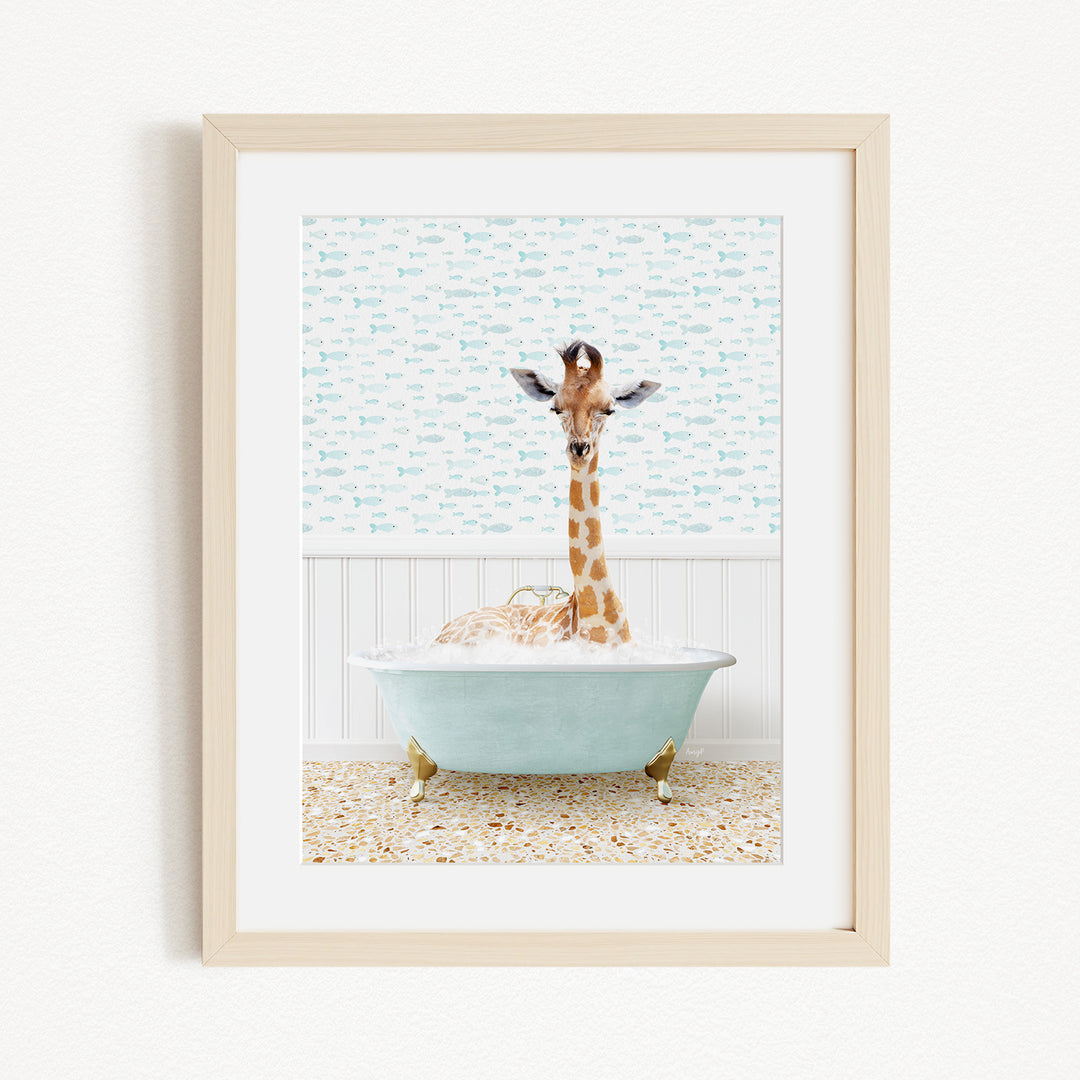 A giraffe standing in a light blue bathtub filled with bubbles, with a patterned wall behind it.