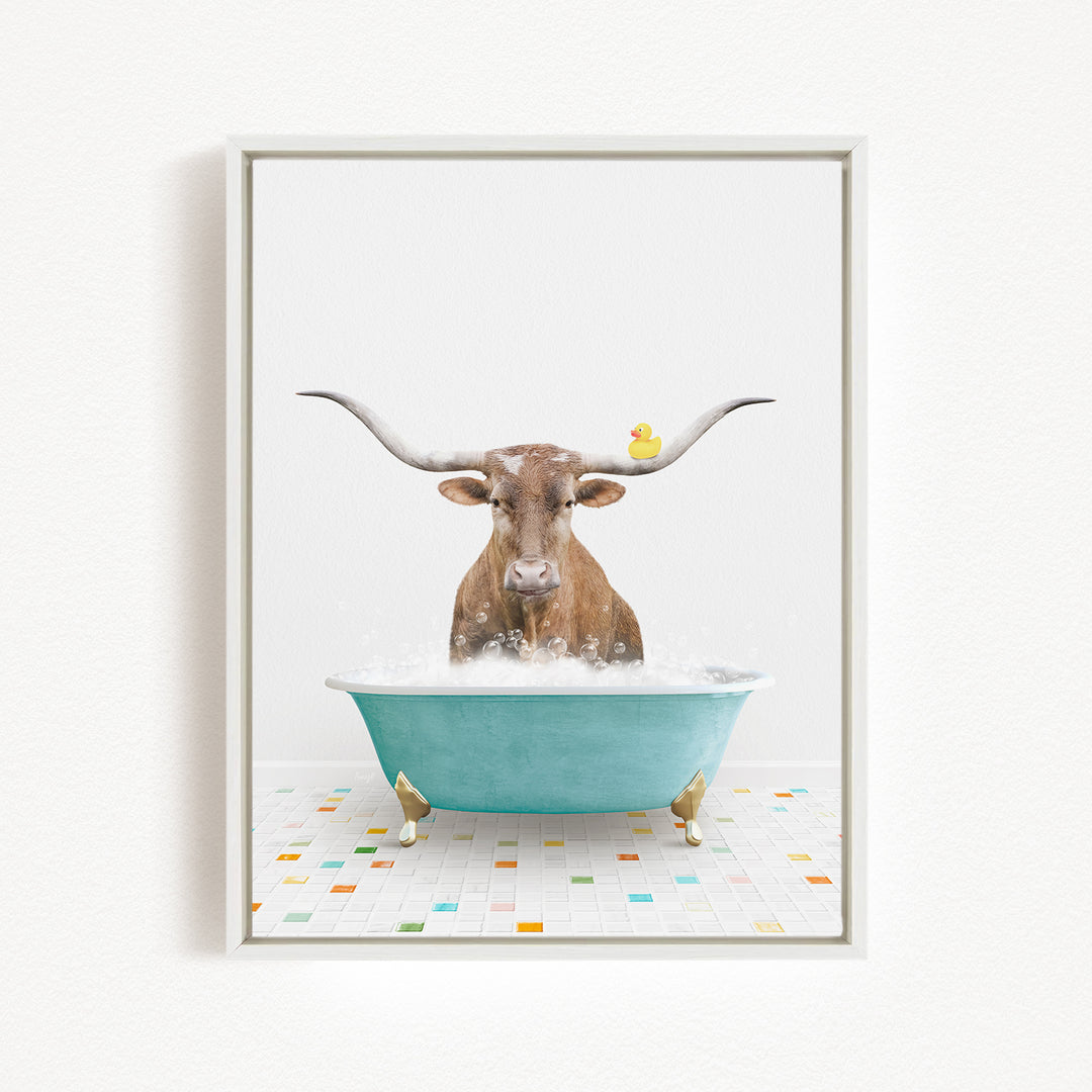 A brown cow with long horns is sitting in a blue bathtub, surrounded by a yellow rubber duck.