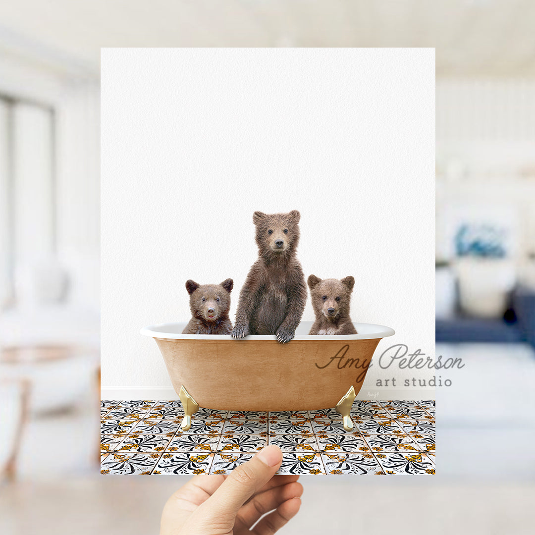 a person holding a card with three bears in a bathtub