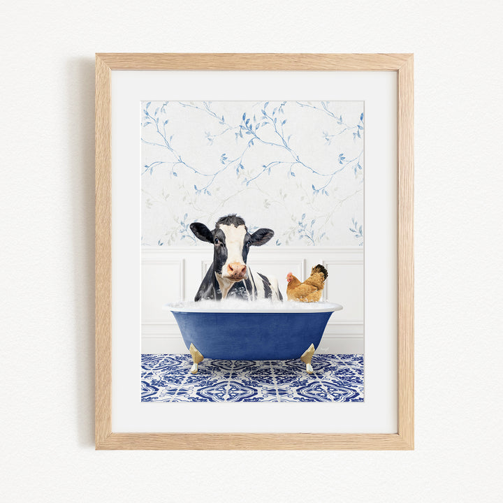 A black and white cow is sitting in a blue bathtub, with a chicken standing nearby, in a bathroom setting with blue floral wallpaper.