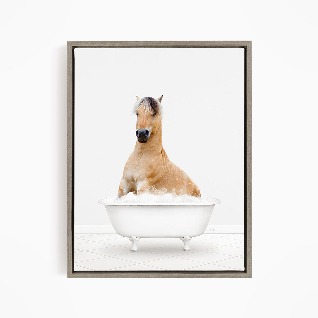 A brown horse sitting in a white bathtub filled with bubbles, looking directly at the camera.