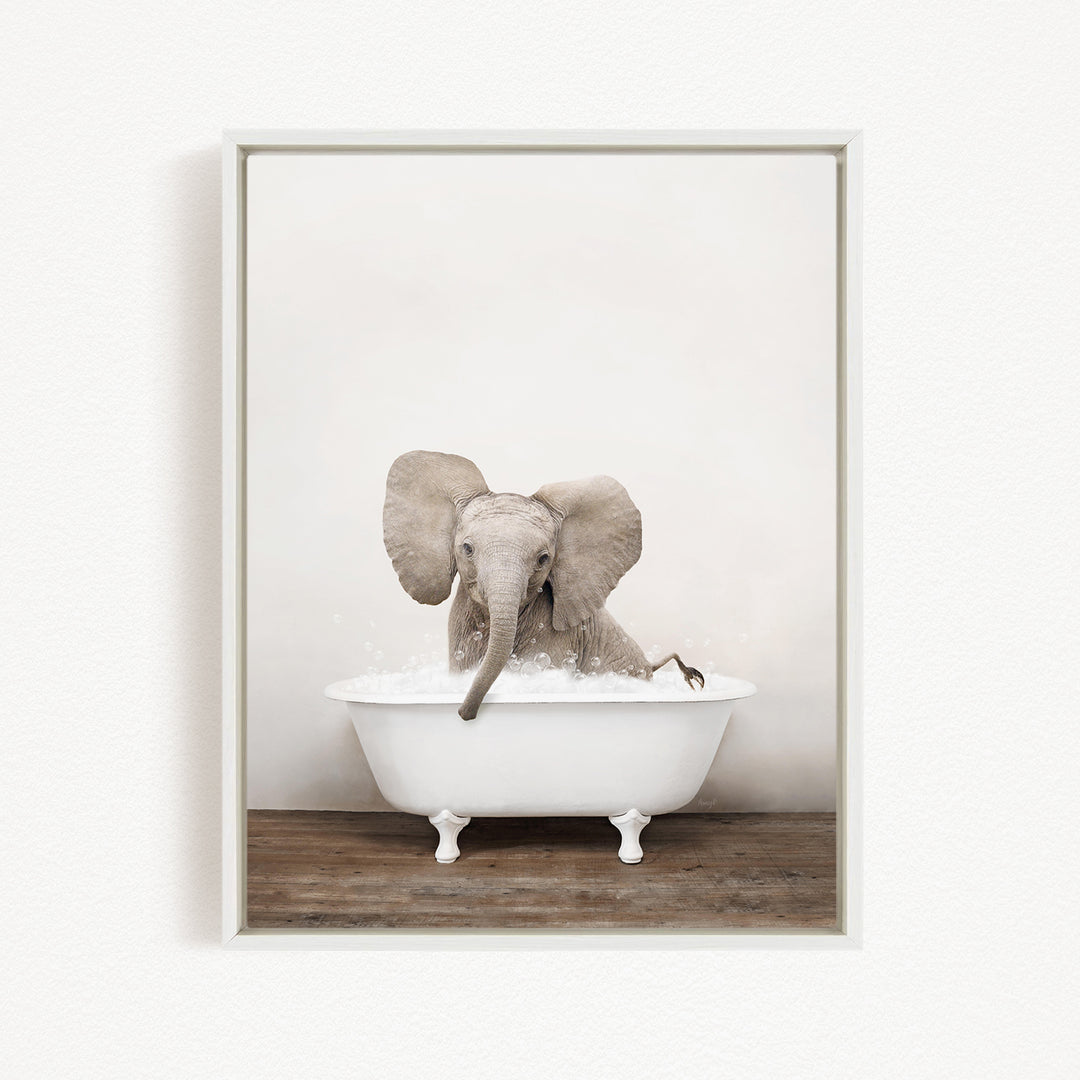 A baby elephant sitting in a white bathtub filled with water, creating a playful and whimsical scene.