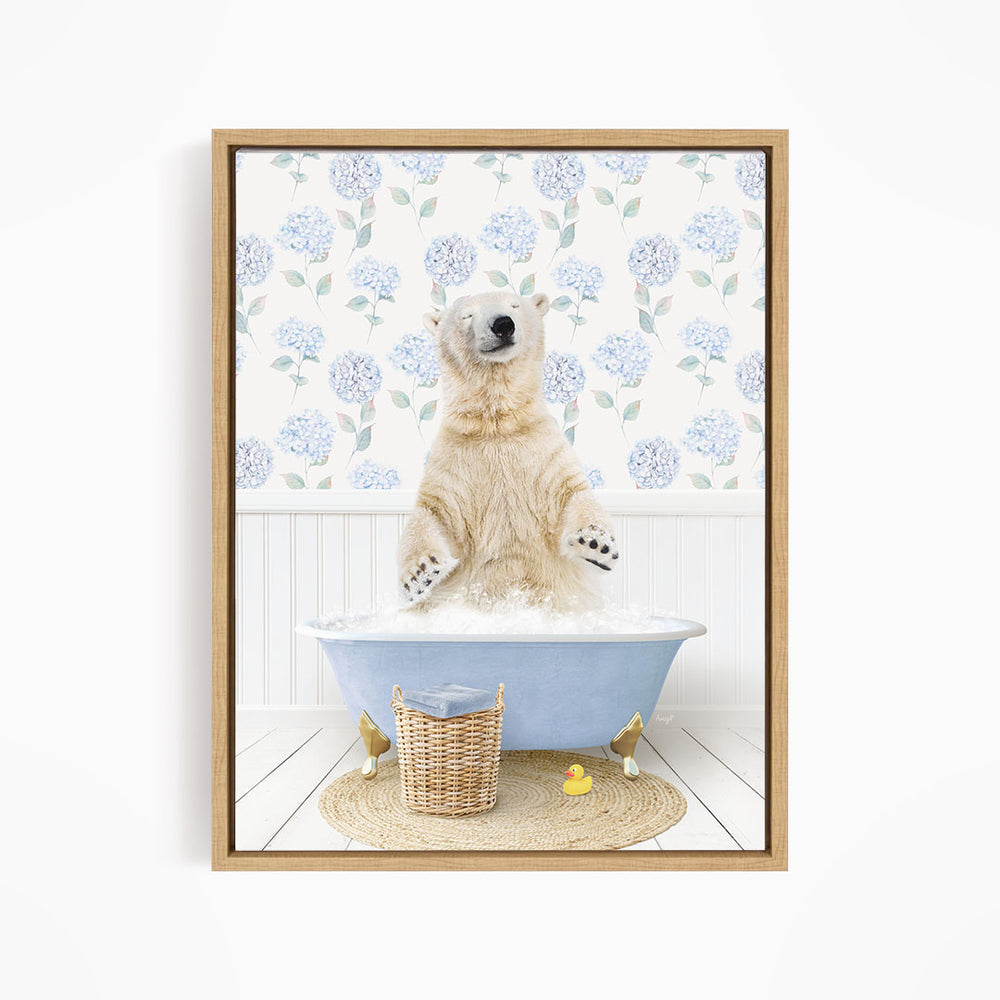 A polar bear is sitting in a blue bathtub filled with water, surrounded by a wicker basket and rubber ducks.