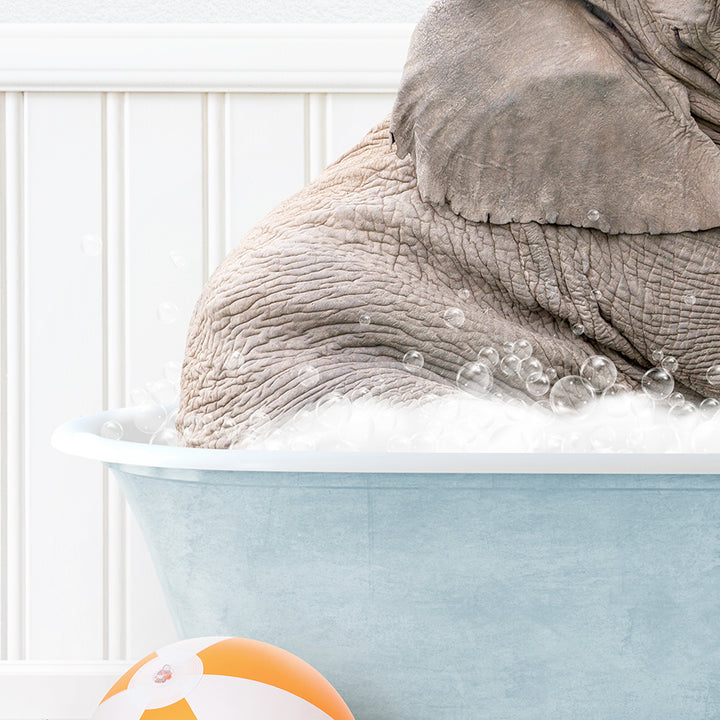 a baby elephant taking a bath in a blue tub