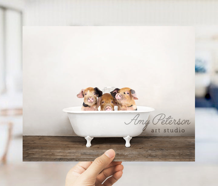 a person holding up a card with three dogs in a bathtub