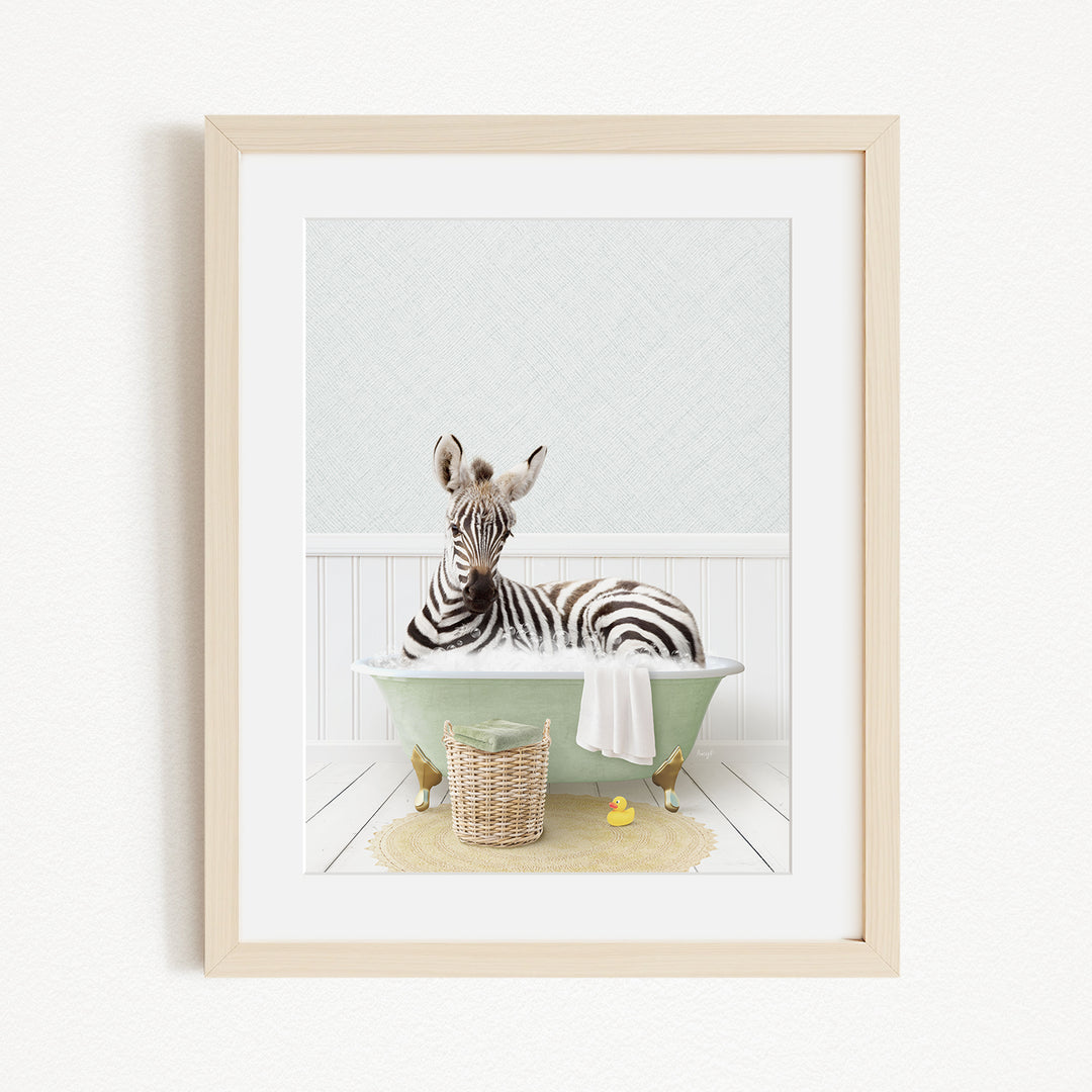 A zebra is sitting in a green bathtub filled with water, surrounded by a basket of toys and a yellow rubber ducky.