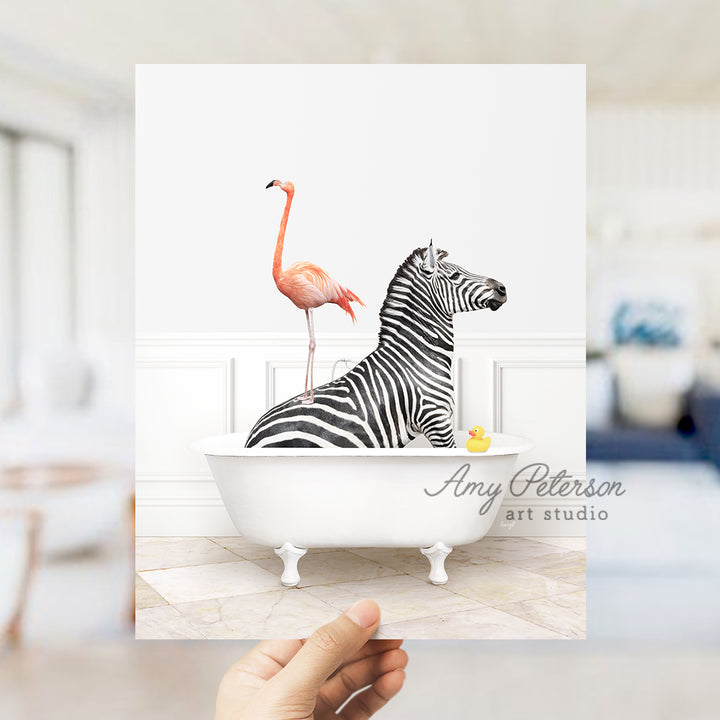 a hand holding a card with a zebra and a flamingo in a bathtub