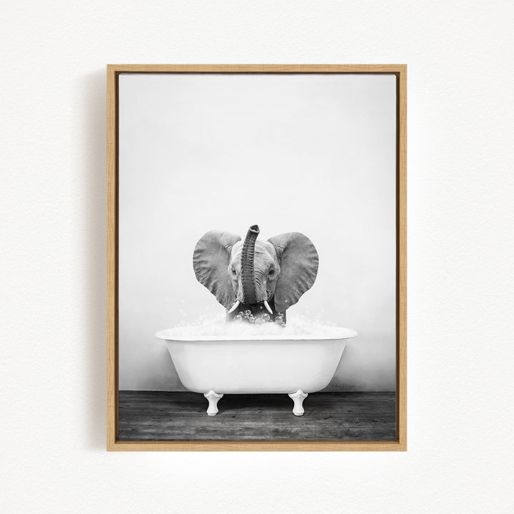 A baby elephant sitting in a white bathtub filled with water, creating a playful and whimsical scene.