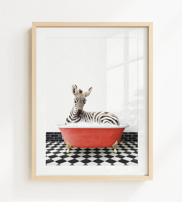 A zebra is sitting in a red bathtub on a black and white checkered floor.