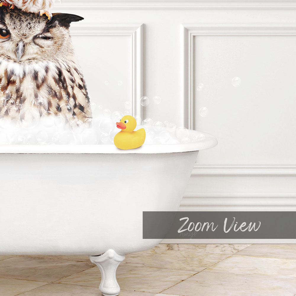 A large owl is sitting in a white bathtub filled with bubbles, with a rubber duck floating nearby.