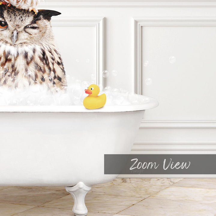 A large owl is sitting in a white bathtub filled with bubbles, with a rubber duck floating nearby.