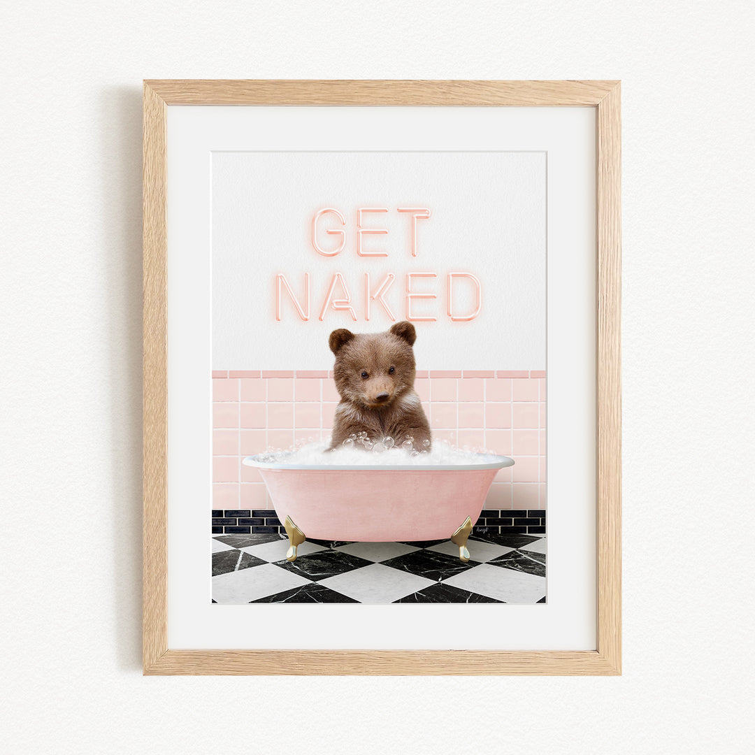 A framed image of a brown bear sitting in a pink bathtub with the text "GET NAKED" written above it.