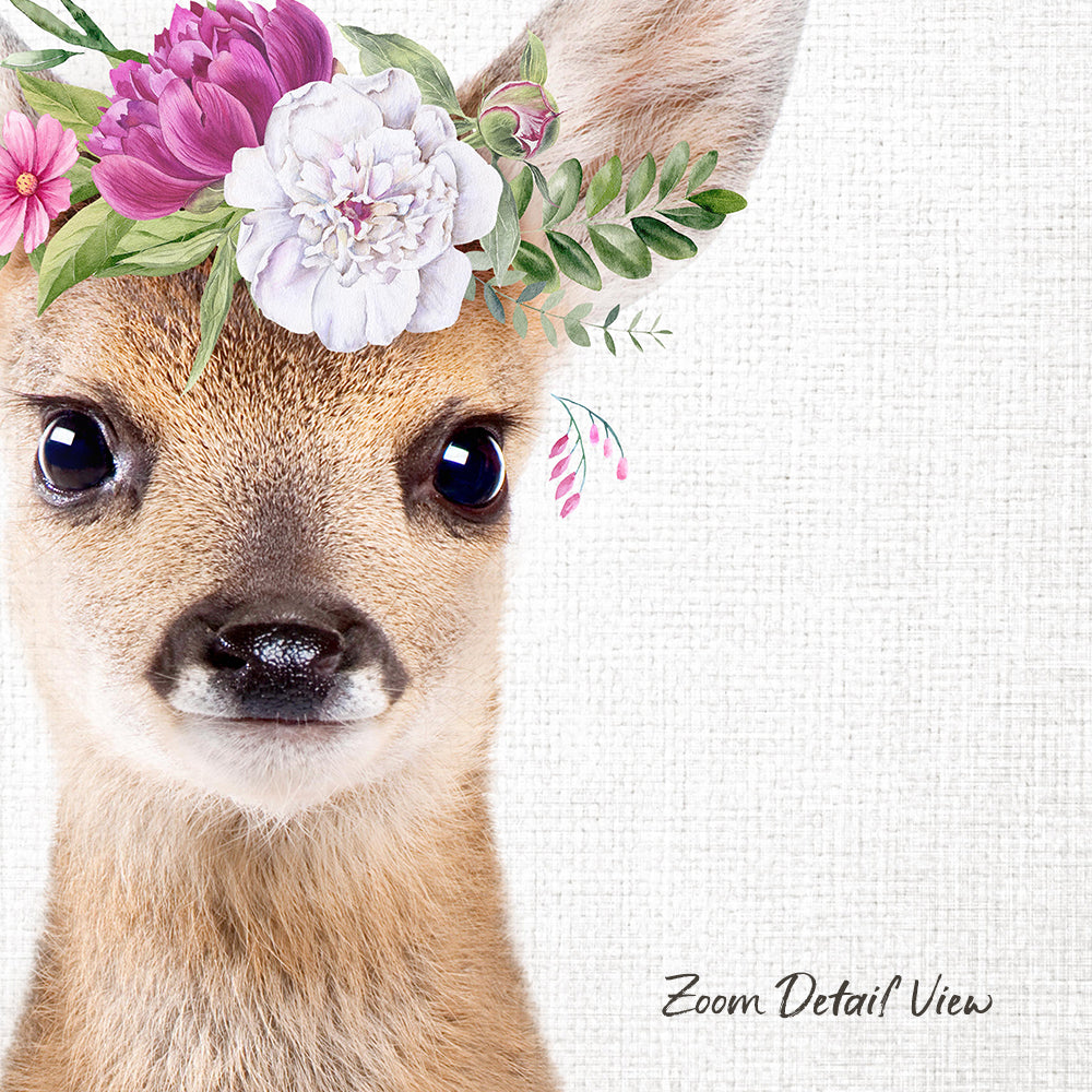 A close-up portrait of a deer with a floral crown on its head, set against a white background.