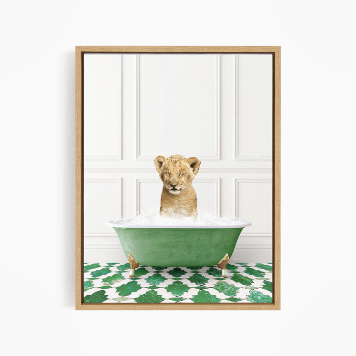 A young lion cub is sitting in a green bathtub filled with water, surrounded by a green and white patterned floor.