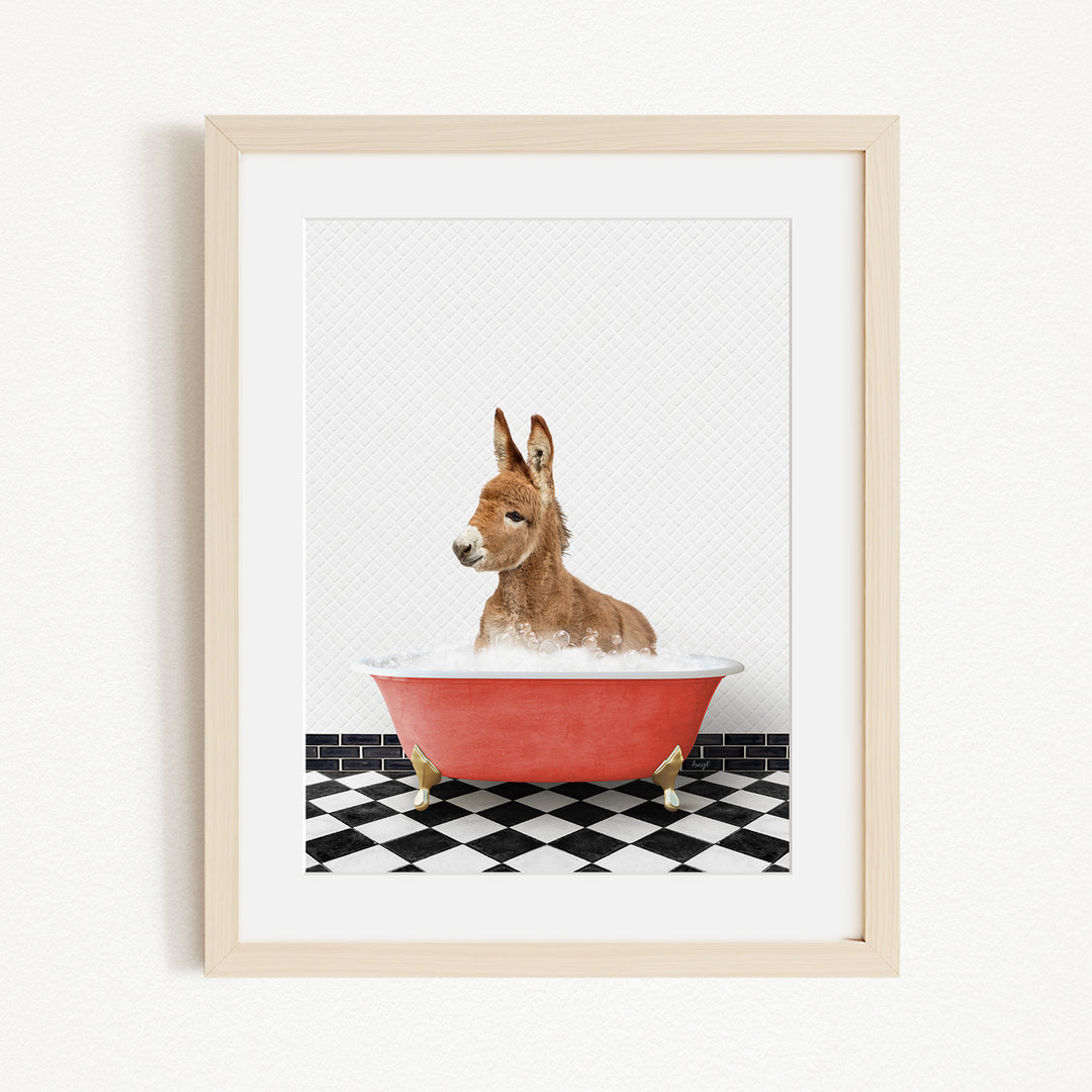 A donkey is sitting in a red bathtub filled with water, surrounded by a black and white checkered floor.