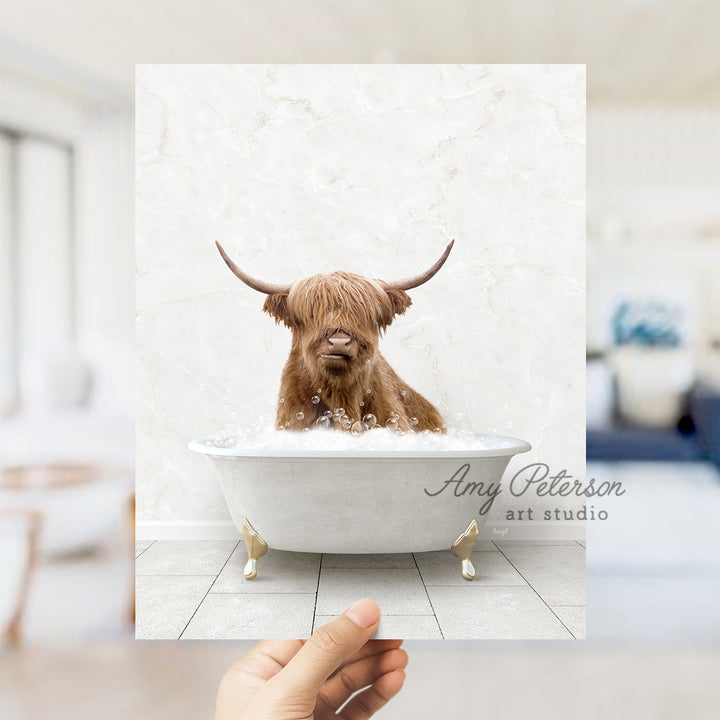 a hand holding up a photo of a dog in a bathtub