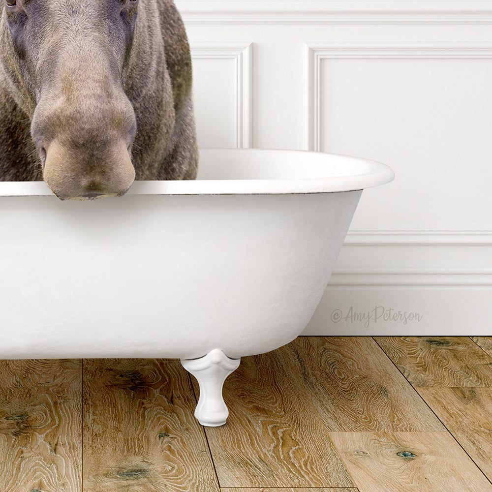 A brown moose is standing in a white bathtub, partially submerged in the water.