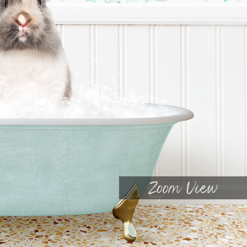 A small, fluffy rabbit sitting in a light blue bathtub filled with bubbles, with a text overlay that reads "Zoom View".