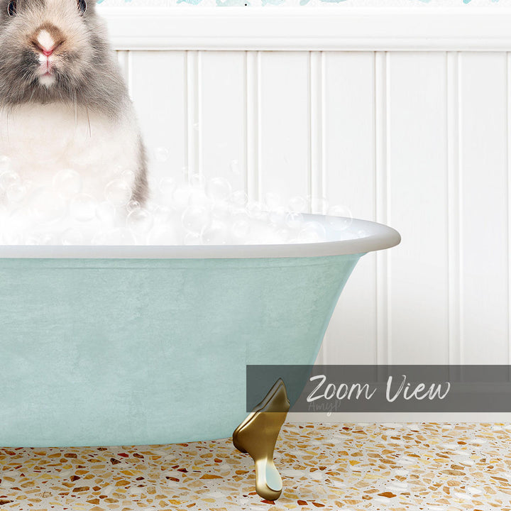 A small, fluffy rabbit sitting in a light blue bathtub filled with bubbles, with a text overlay that reads "Zoom View".