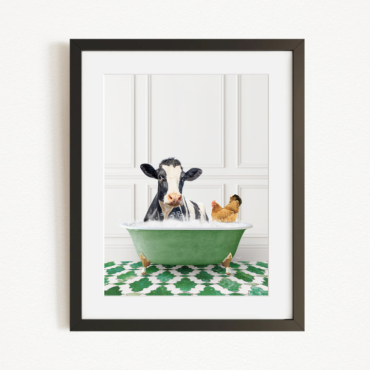 A black and white cow is sitting in a green bathtub, with a chicken standing nearby, in a framed image.