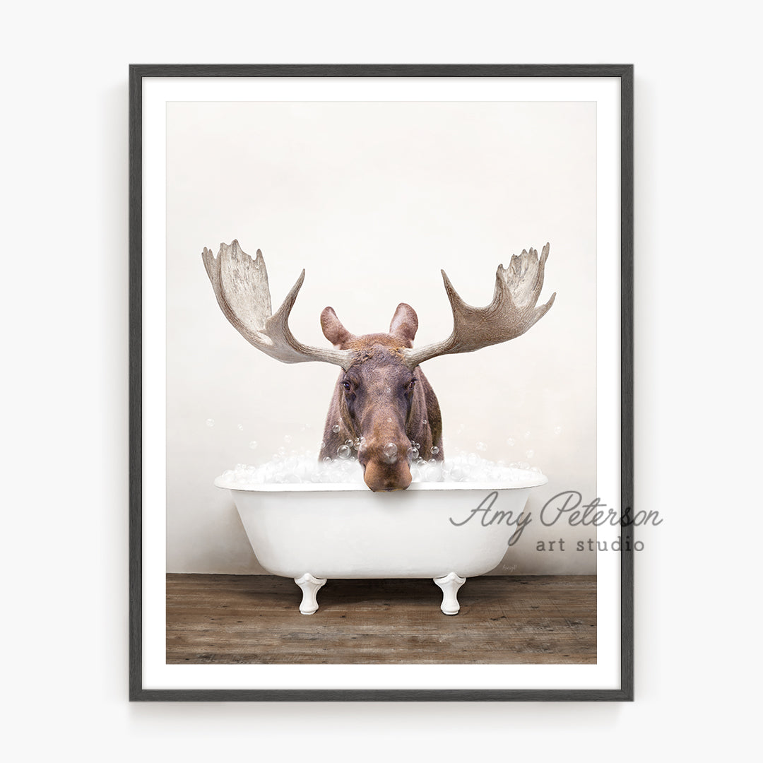 a moose is taking a bath in a bathtub