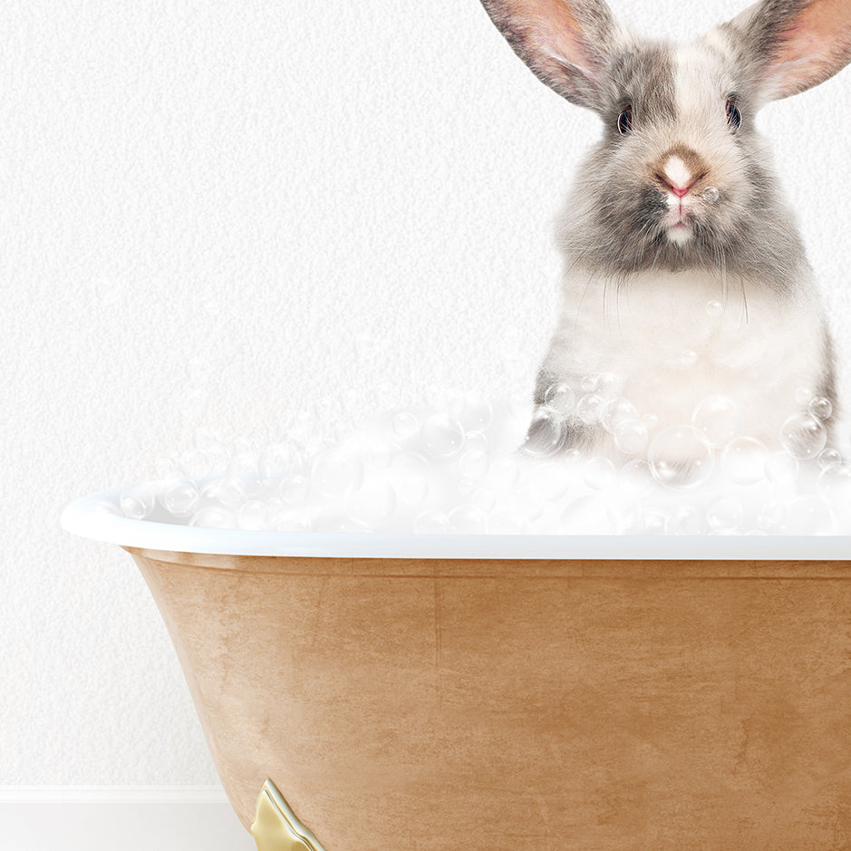 a rabbit sitting in a bathtub with bubbles