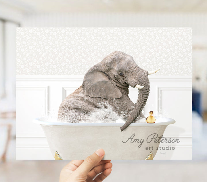 a person holding up a picture of an elephant in a bathtub