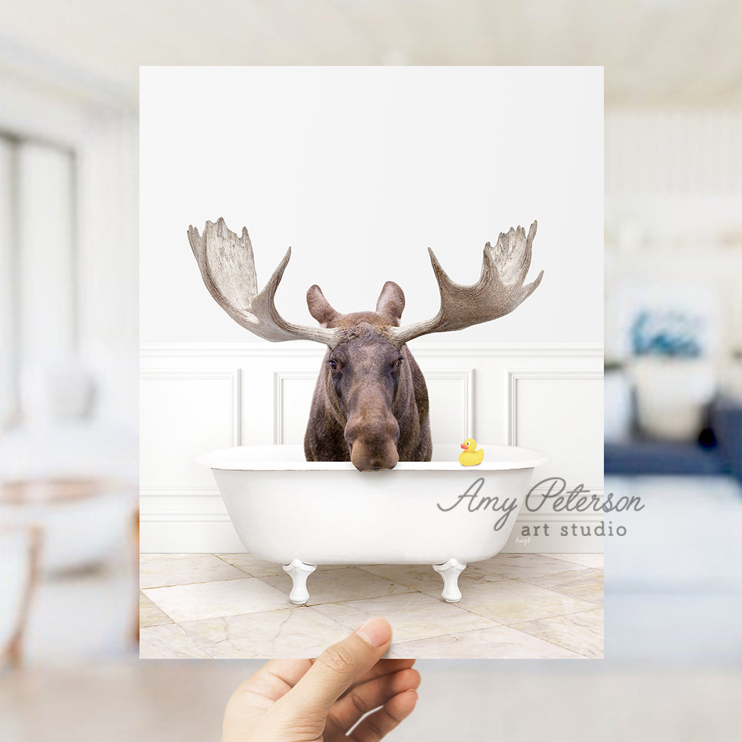 a person holding up a card with a picture of a moose in a bathtub