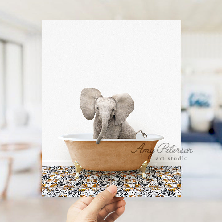 a hand holding a card with an elephant in a bathtub